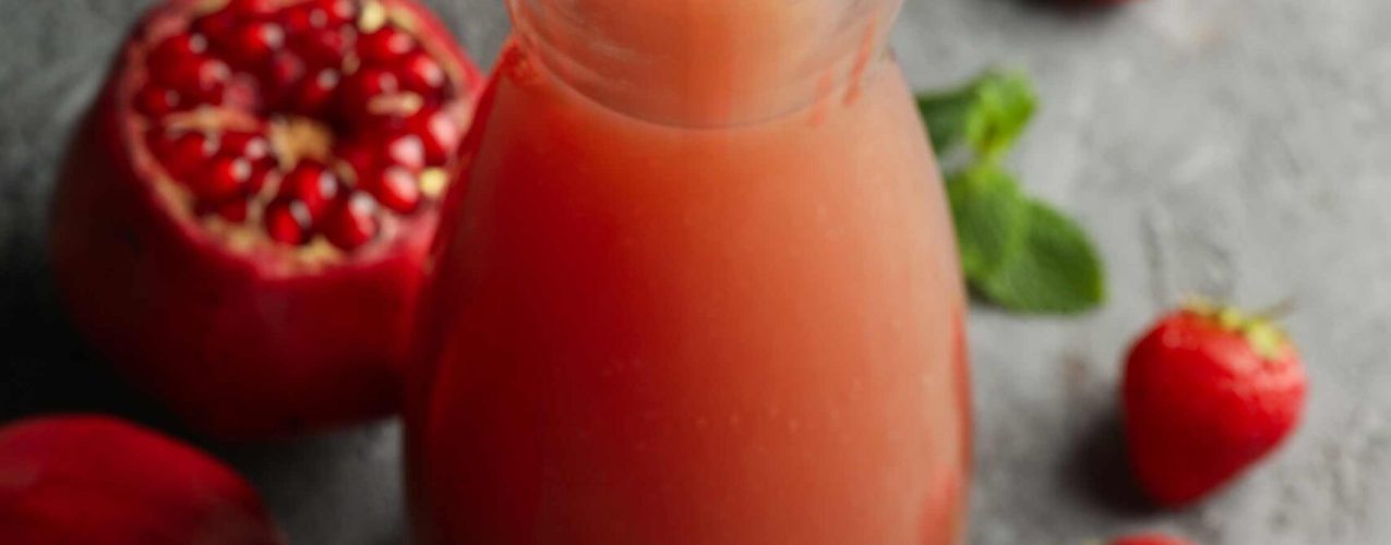 bottle-jug-with-pomegranate-juice-on-gray-backgr-2023-11-27-05-18-03-utc
