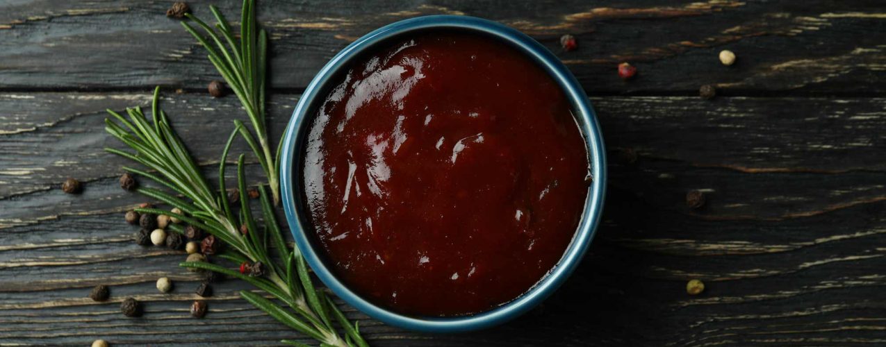 bowl-of-barbecue-sauce-and-spices-on-wooden-backgr-2023-11-27-04-59-05-utc