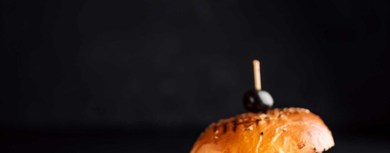 delicious-burger-and-onion-rings-on-dark-backgroun-2024-10-17-11-09-16-utc